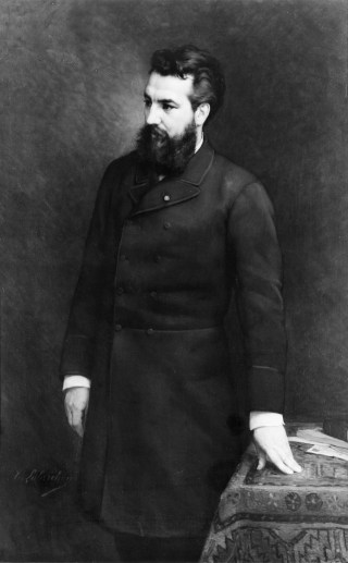 Alexander_Graham_Bell,_three-quarter_length_portrait,_standing,_facing_left_c.1882
