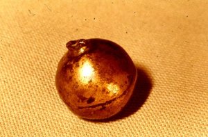 The "kulknappen," or "bullet-button" discovered in 1924 and believed by some to have been the projectile used to kill Charles XII. A recent investigation discovered it bore fragmentary traces of the same group of DNA as the blood that still stains King Charles's gloves.